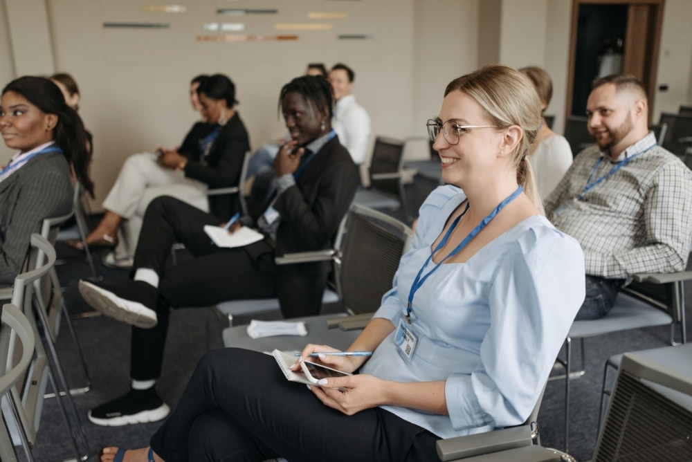 A group of professionals attentively listening during a networking event or seminar.