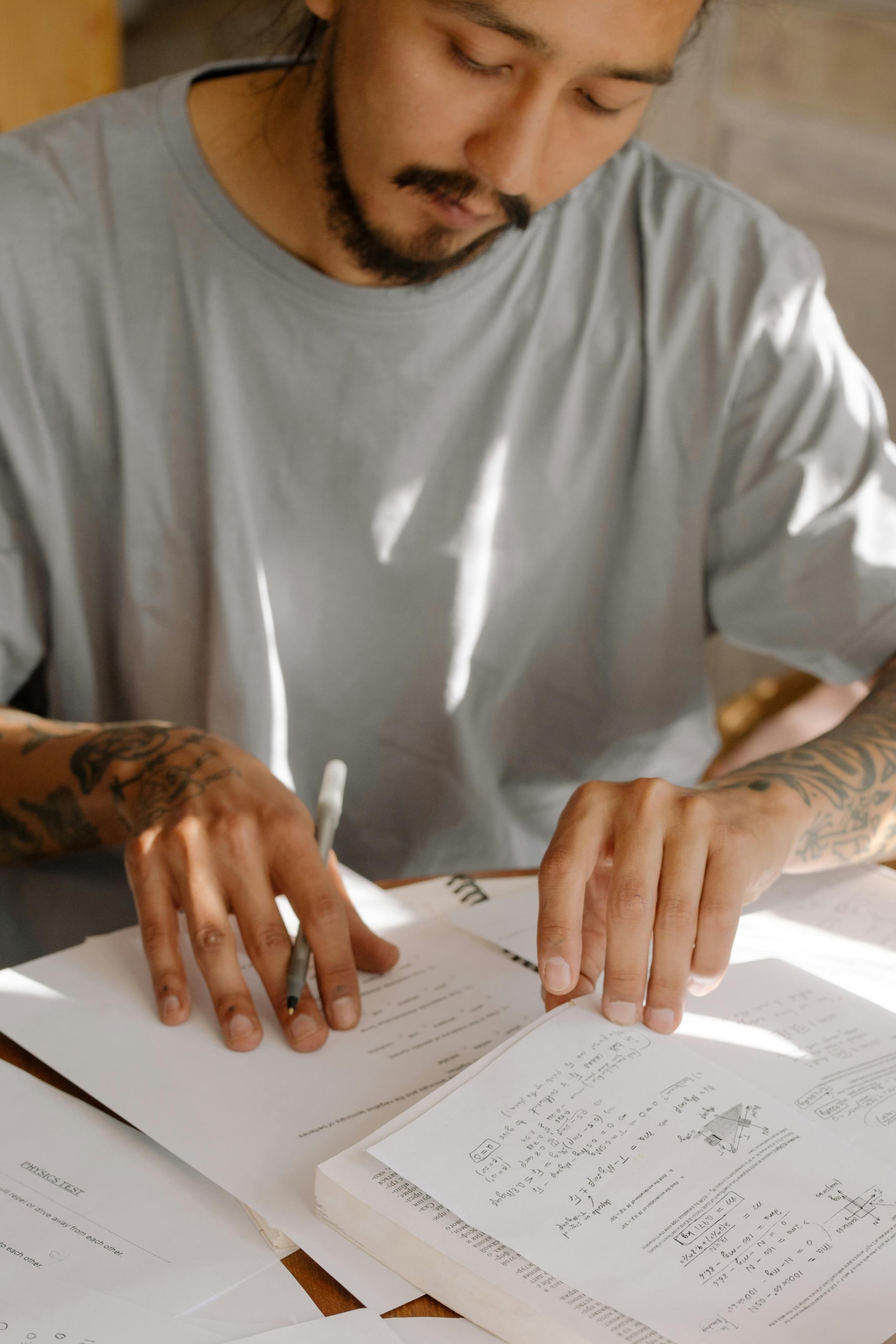 A college student sits at a desk and works on math homework.