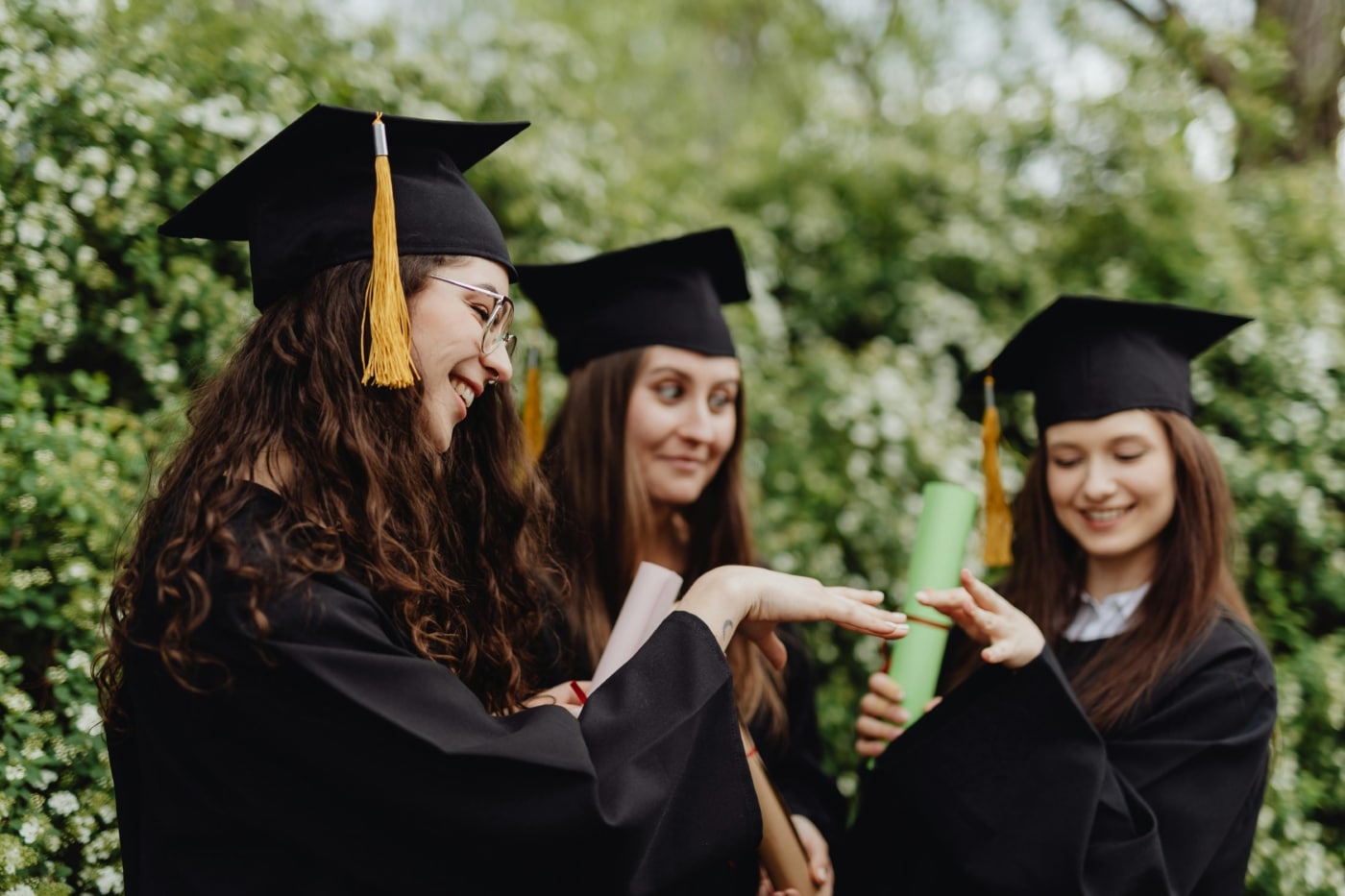 A group of graduates stand together.