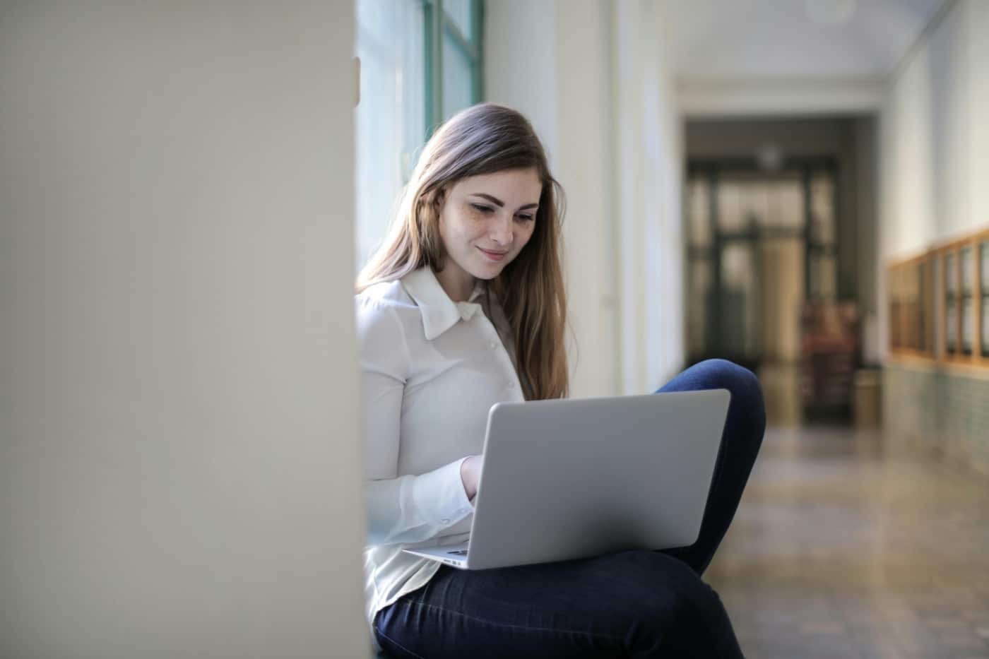 A woman uses a laptop.