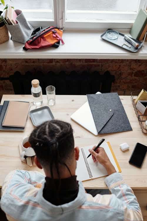 A student works on homework at a desk.