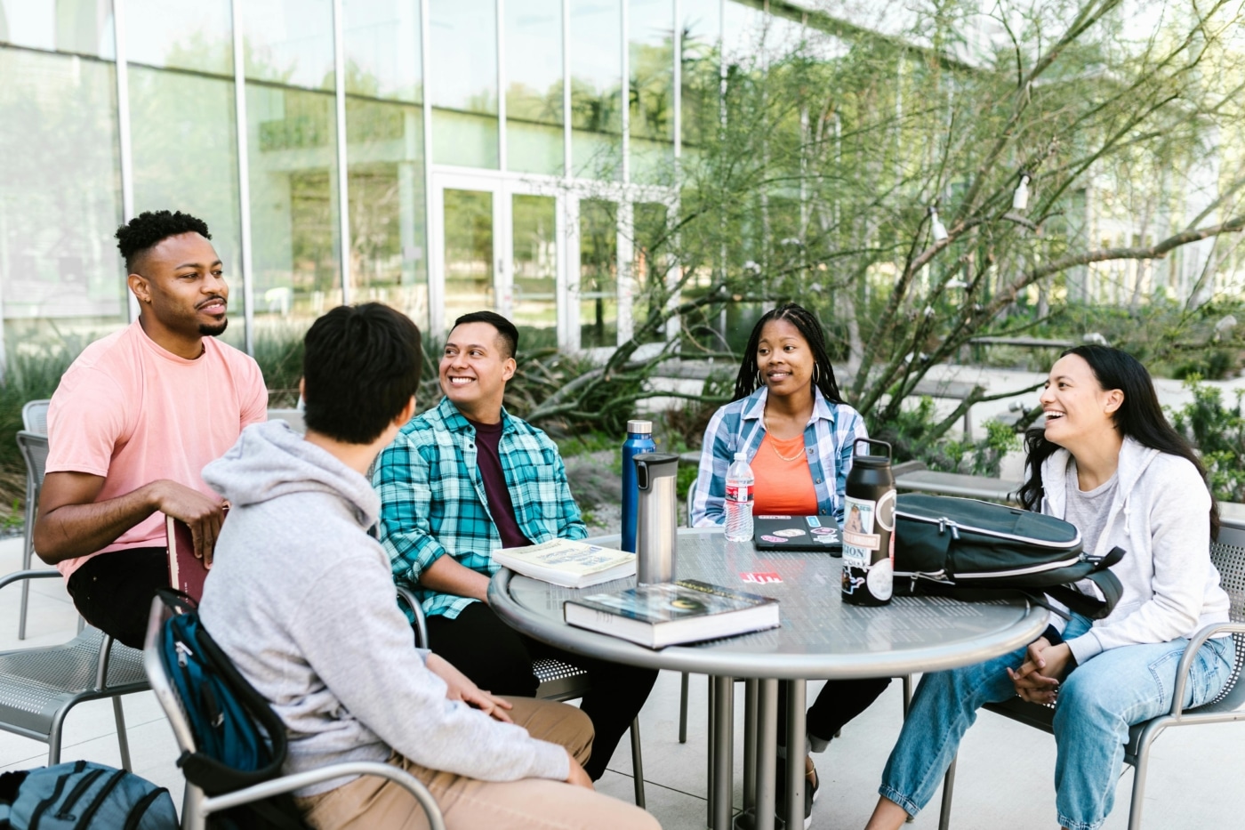 Five college students sit at a table