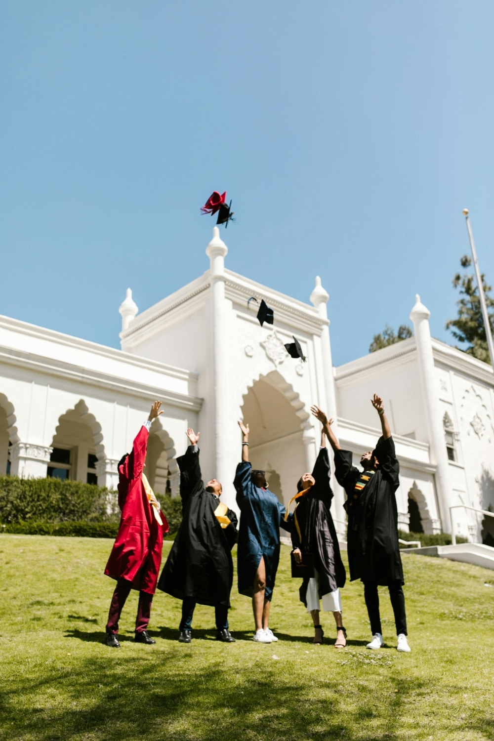 Group of college graduates throwing their caps in the air.