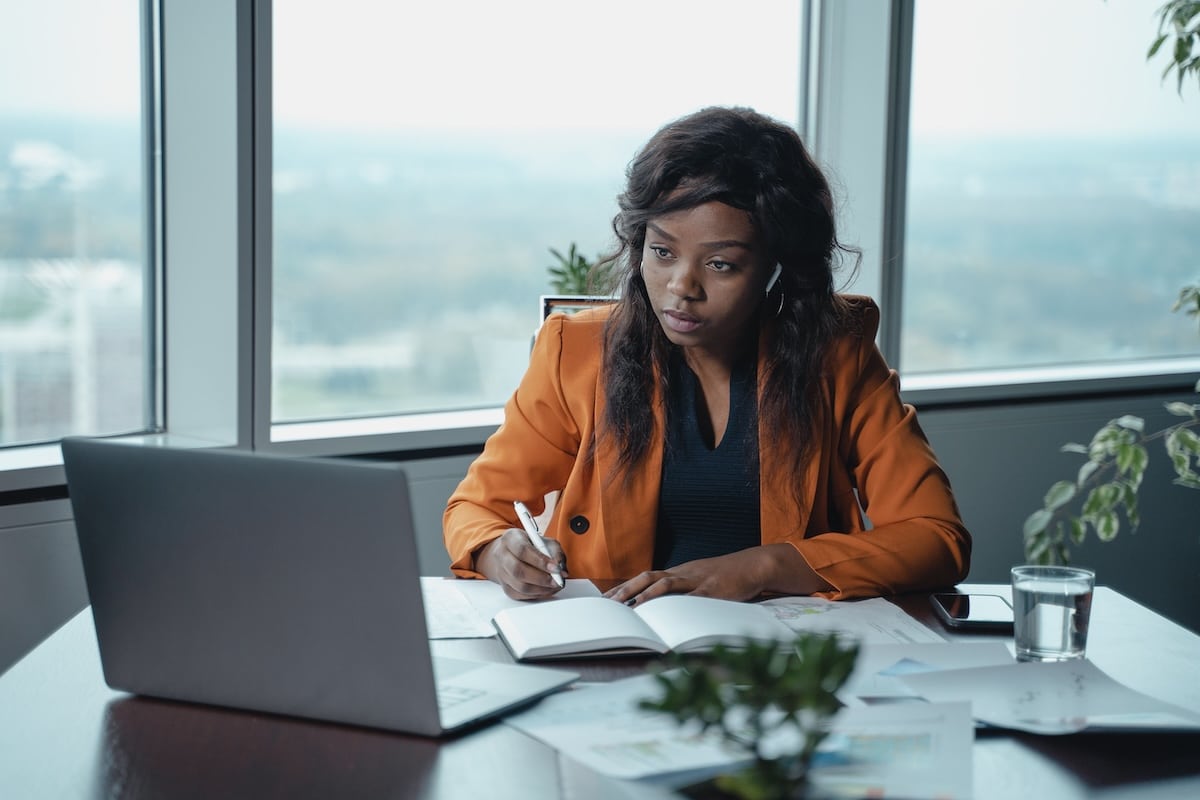 Advisor reviewing student messages on a laptop, representing human oversight in an AI-supported workflow